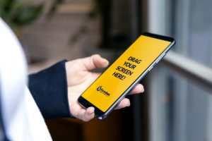 Close-up of a person holding a smartphone with a customizable screen, perfect for app demos.